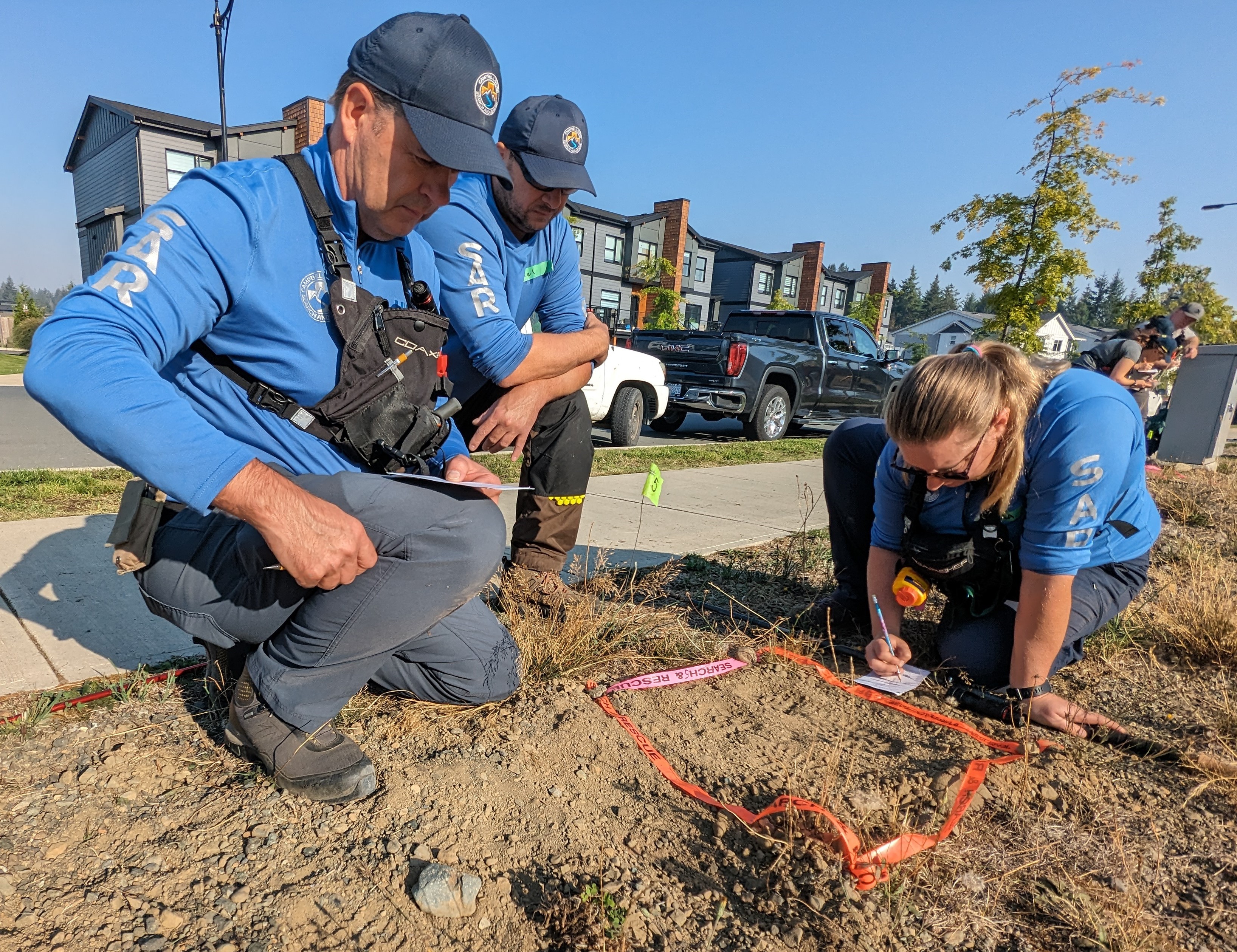 Three members from Campbell River Search and Rescue working on a starting print in a Track Aware course